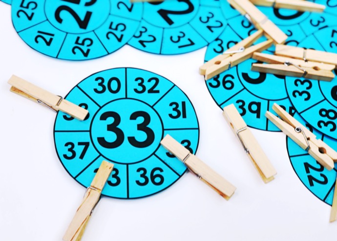 Number recognition activities: number clip cards. Target number 33 in the center of the card. Students clip matching number around the edge of the circular card.