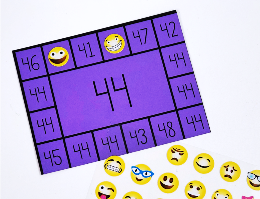 Number recognition activities: number punch cards. Number 44 card with happy face stickers on 2 space.